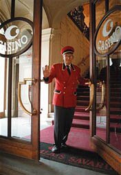 A porter waves at the Palace Casino on Na Prikope in Prague in May 1998. The internationally owned Palace Casino is forced to sell its business to a Czech company because the Czech Parliament passed a law which is forcing all non-Czech companies to sell their casinos. (Photo by Ami Vitale)