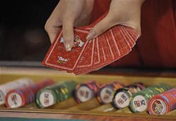 Card dealers demonstrate their latest products at the gaming expo in Macau on June 04, 2008. More than 6,000 gaming professionals from around the world are expected to converge on the giant Venetian casino resort for the Global Gaming Expo Asia (G2E Asia) 2008, double the number from last year. The three-day event will showcase the latest slot machines, security software, gaming devices and even weapons detectors from more than 180 international suppliers.