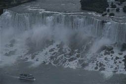 A boat full of tourists is seen in the foreground. Niagara Falls, Ontario, Canada. (Photo by Todd Gipstein/National Geographic/Getty Images)