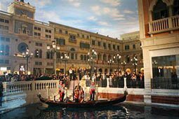 Dr Miriam Adelson and Sheldon G Adelson Chairman of the Board and CEO Las Vegas Sands Corp greet a Malaysian couple who arrived on a gondola during the opening ceremony at the Venetian in Macau 28 August 2007. The Venetian Macao, the world's biggest casino by gaming tables, opens to the public in an attempt to trump its rivals not only as a gambling paradise but an entertainment centre. AFP PHOTO/MIKE CLARKE